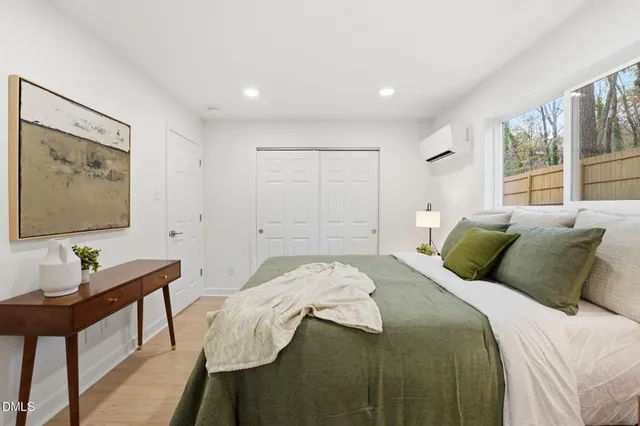 a bedroom with a bed and a lamp on table