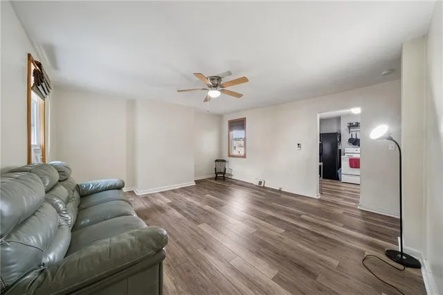 a living room with furniture and a ceiling fan