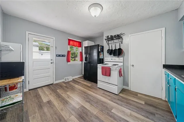 a view of a workspace with furniture and wooden floor