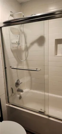 a bathroom with a bathtub and a shower