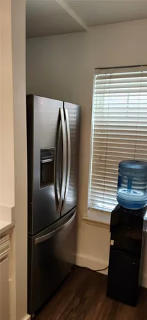 a metallic refrigerator freezer sitting in a kitchen