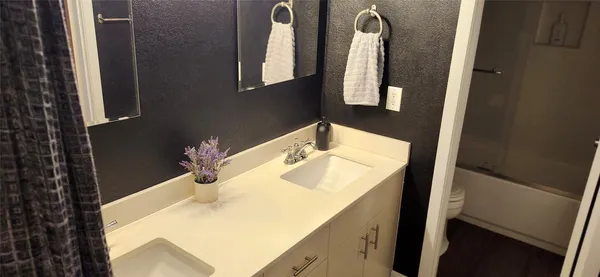 a bathroom with a sink and mirror