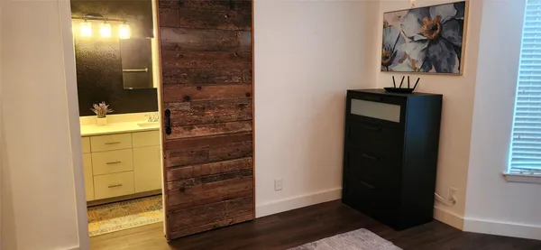 a view of a hallway with wooden floor