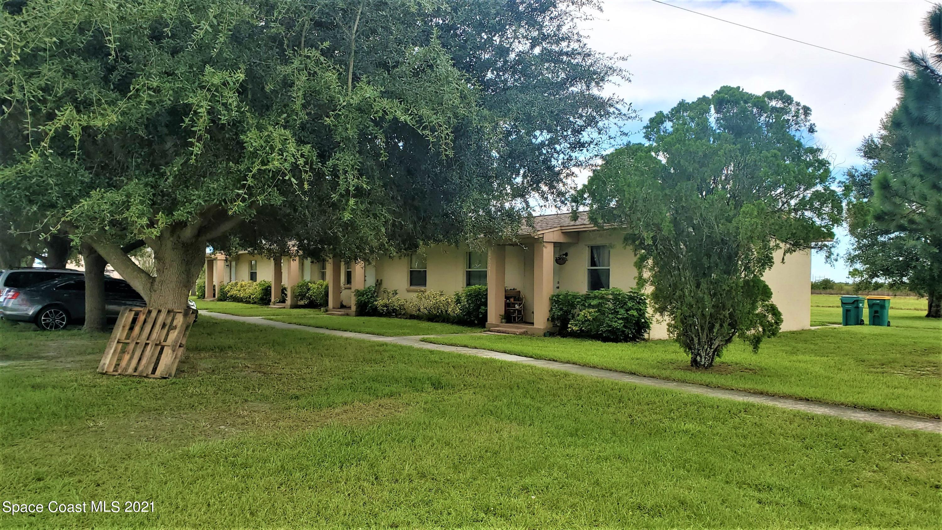 4521 Micco Road Micco, FL 32976 - Photo 4 of 12 a front view of a house with a yard