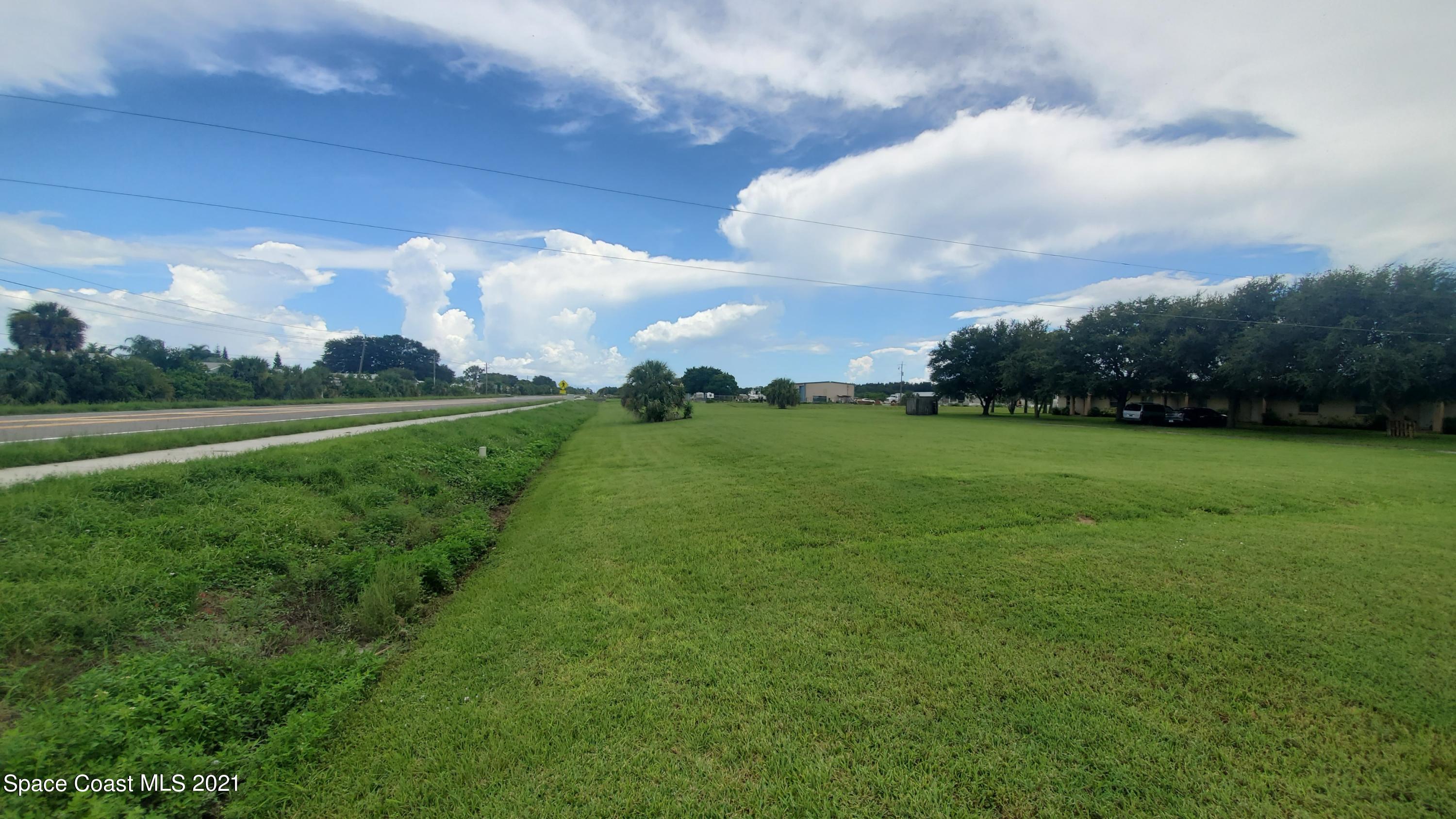 4521 Micco Road Micco, FL 32976 - Photo 7 of 12 a view of a big yard with plants and large trees