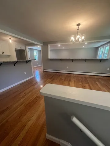 a view of a room with wooden floor
