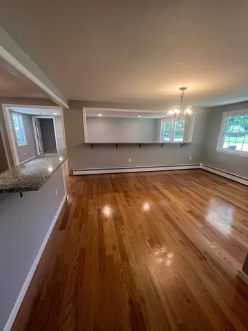 a view of a room with wooden floor and staircase