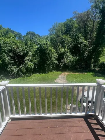 a view of a wooden deck with a yard