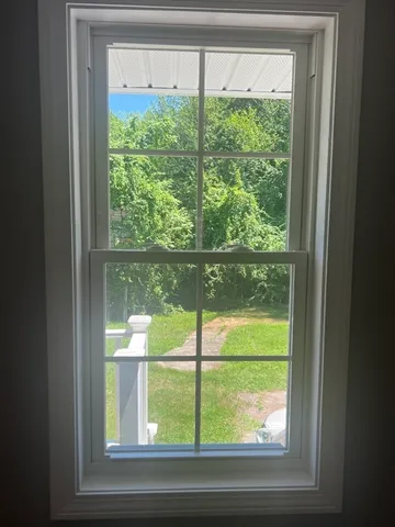 a view of a room that has a bed and a window