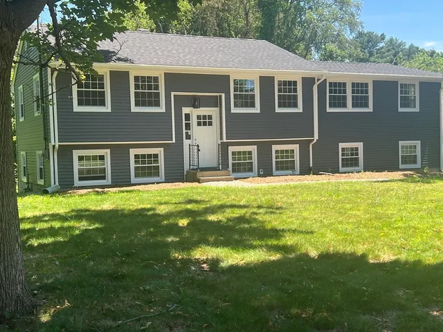 a front view of a house with a garden