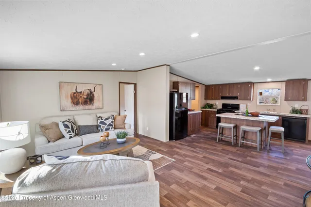 a living room with furniture kitchen view and a dining table
