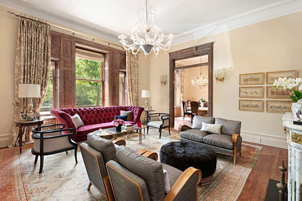 a living room with furniture and a chandelier