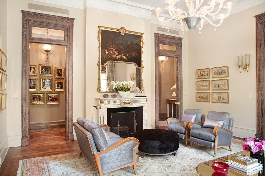 1 West 72nd Street, Unit 1011 Manhattan, NY 10023 - Photo 3 of 14 a living room with furniture a fireplace and a chandelier