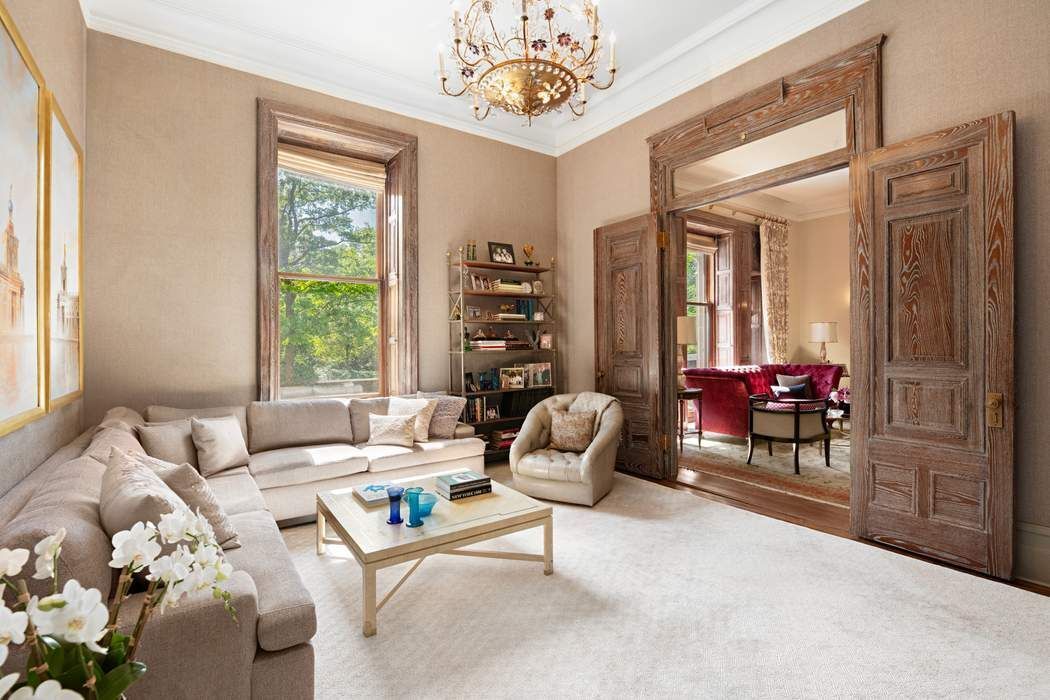 1 West 72nd Street, Unit 1011 Manhattan, NY 10023 - Photo 5 of 14 a living room with furniture and a large window