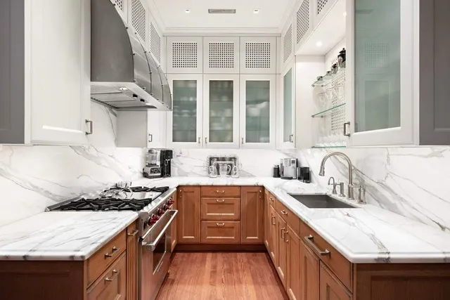 a kitchen with a sink stove top oven and cabinets
