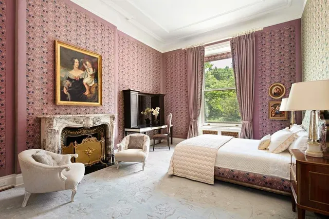 a bedroom with a bed and a fireplace