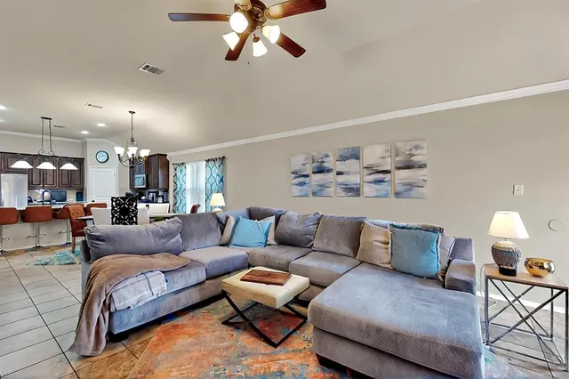 a living room with furniture and kitchen view