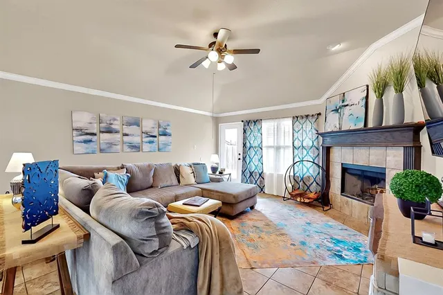 a living room with furniture a fireplace and a chandelier