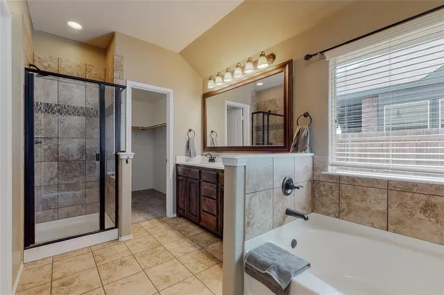 a bathroom with a tub sink and mirror