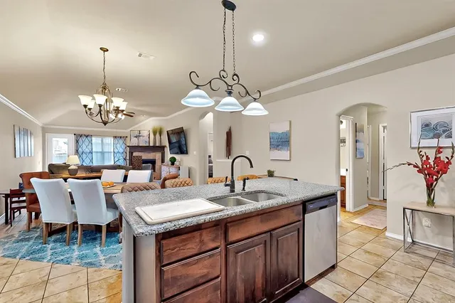 a dining room with a chandelier and living room view