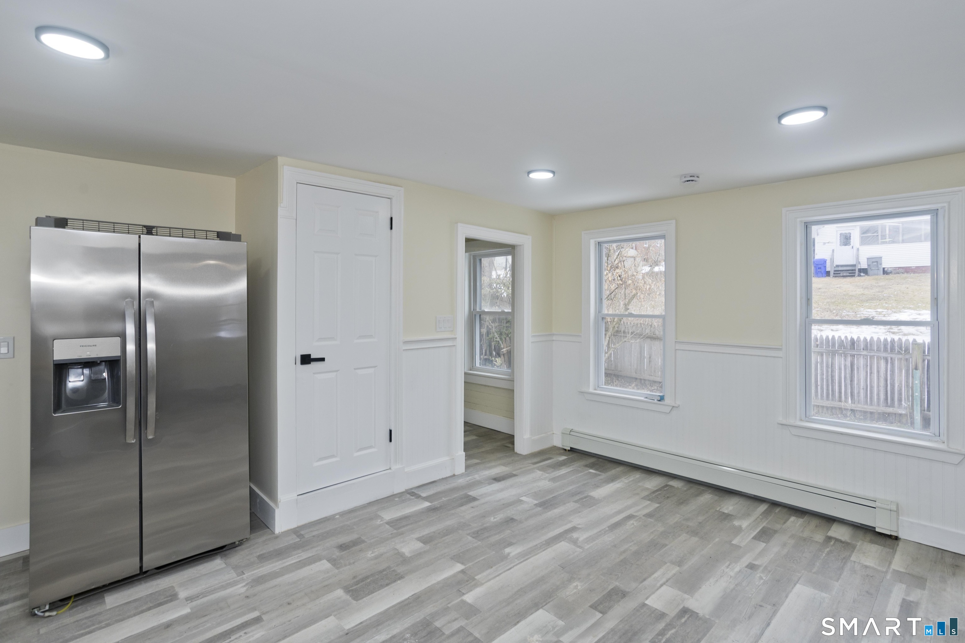 47 Maple Avenue Enfield, CT 06082 - Photo 23 of 36 an empty room with wooden floor cabinet and windows