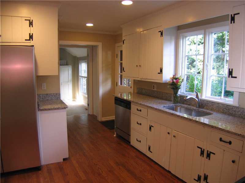 1 Devon Road Darien, CT 06820 - Photo 4 of 19 a kitchen with granite countertop a sink and a refrigerator