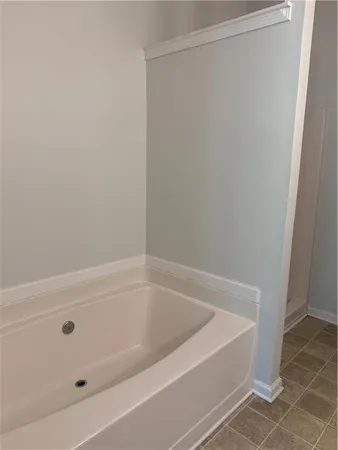 a white bath tub and shower in a bathroom