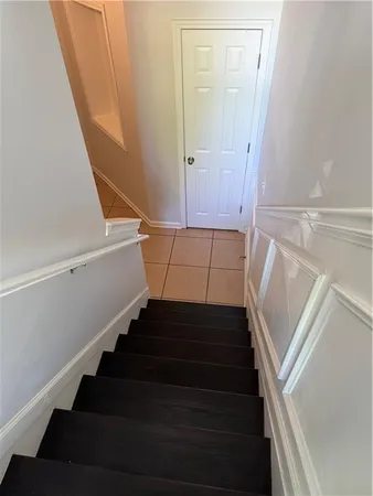 a view of staircase with white walls and a window
