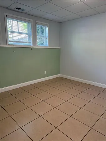 a view of a room that has a fan and window
