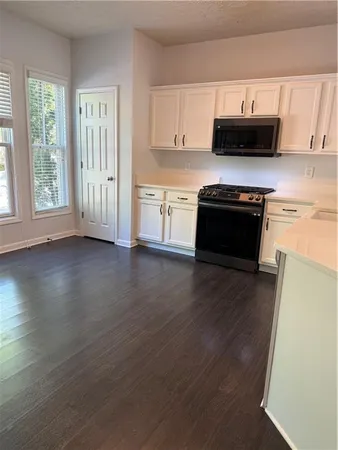 a kitchen with stainless steel appliances a stove a microwave and sink