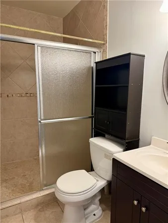 a bathroom with a toilet a sink and shower