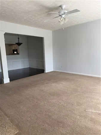 a view of an empty room with a ceiling fan