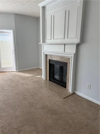 a view of empty room with a fireplace