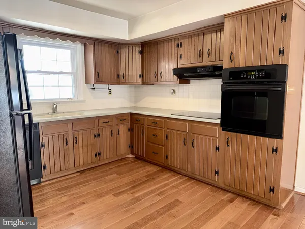 a kitchen with wooden cabinets and a sink