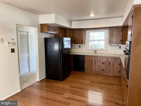 a kitchen with stainless steel appliances granite countertop a refrigerator a sink and a stove