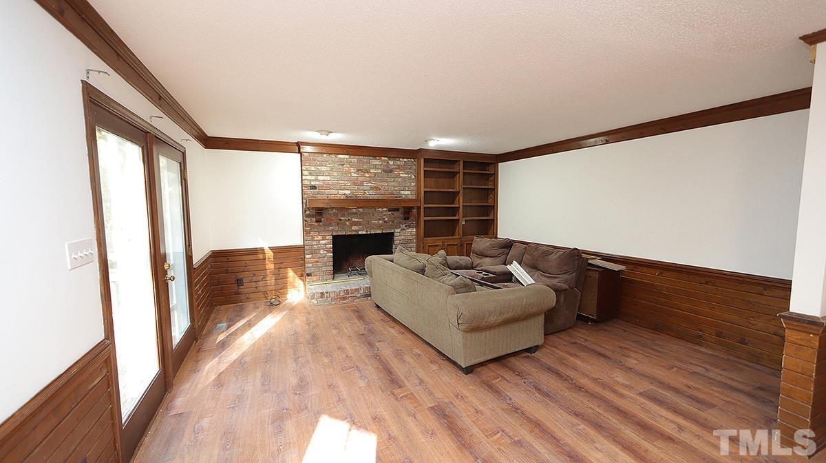 2024 Corberrie Lane Raleigh, NC 27613 - Photo 8 of 30 a living room with furniture fireplace and flat screen tv