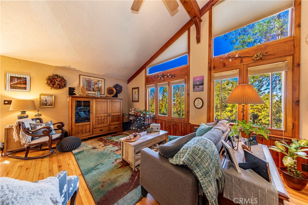 5757 Clouds Rest Mariposa, CA 95338 - Photo 22 of 68 a living room with furniture a flat screen tv and a floor to ceiling window
