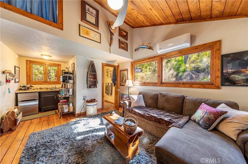 5757 Clouds Rest Mariposa, CA 95338 - Photo 23 of 68 a living room with furniture a flat screen tv and a floor to ceiling window