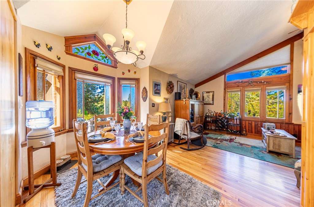 5757 Clouds Rest Mariposa, CA 95338 - Photo 28 of 68 a dining room with furniture a chandelier and wooden floor