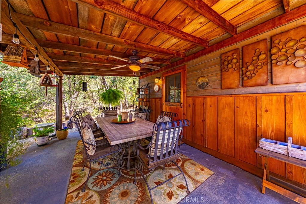 5757 Clouds Rest Mariposa, CA 95338 - Photo 33 of 68 a view of a patio with a table and chairs next to a yard with wooden fence