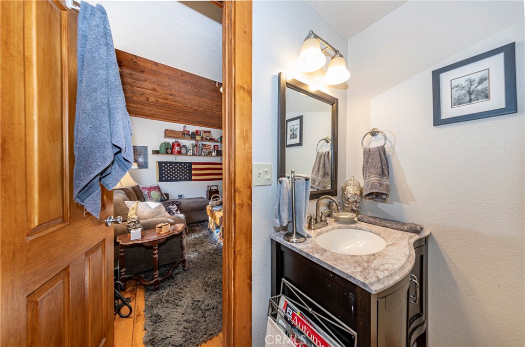 5757 Clouds Rest Mariposa, CA 95338 - Photo 38 of 68 a en suite bathroom with a sink vanity and mirror