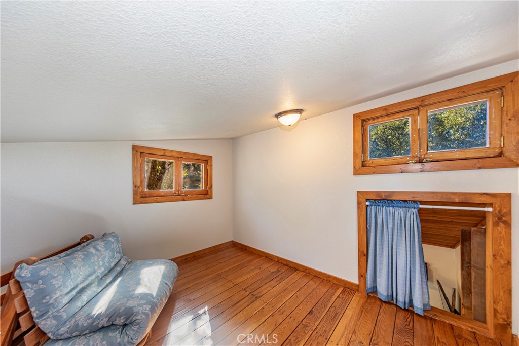 5757 Clouds Rest Mariposa, CA 95338 - Photo 39 of 68 a bedroom with a bed and wooden floor