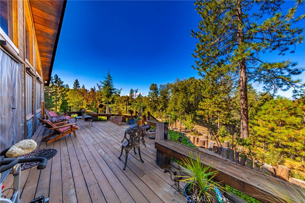 5757 Clouds Rest Mariposa, CA 95338 - Photo 45 of 68 a view of a balcony with chairs and wooden floor