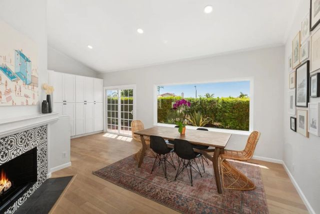 a bedroom with a large bed a chandelier and a fireplace