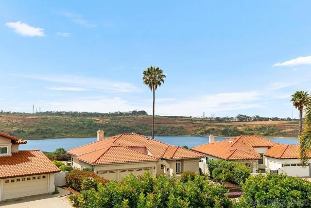 a bedroom with two beds and painting on the wall