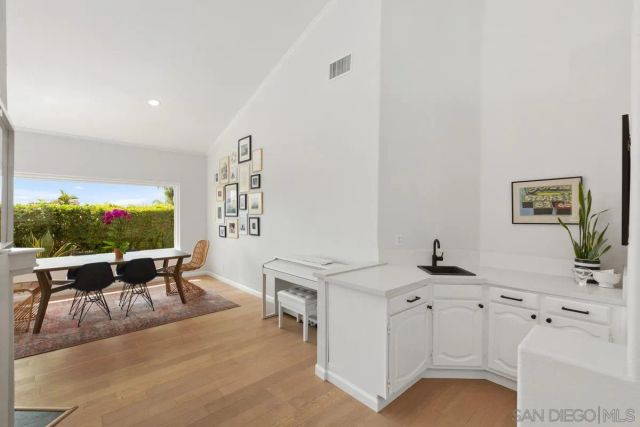 a dining room with furniture window and wooden floor