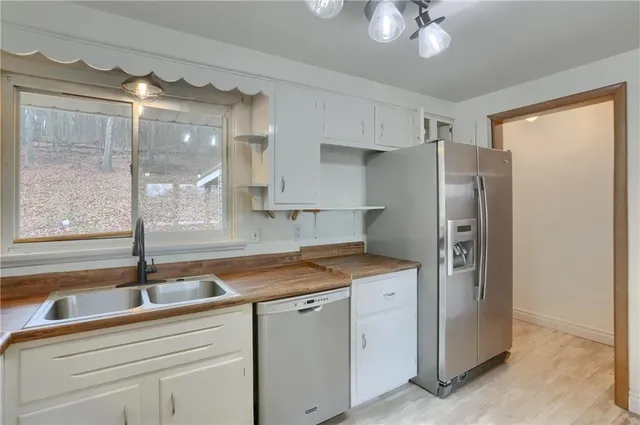 a kitchen with a sink and refrigerator
