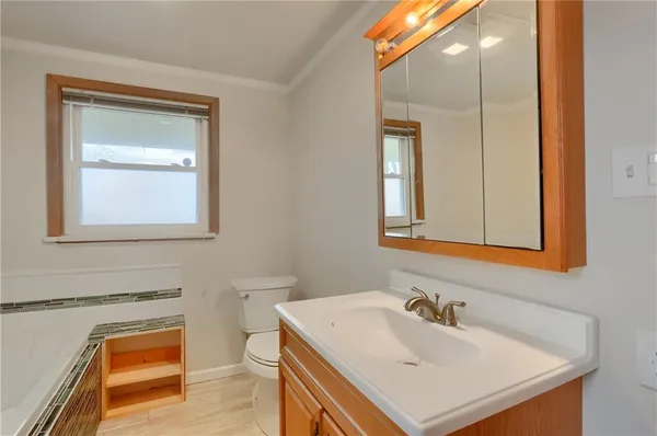 a bathroom with a sink a toilet and mirror