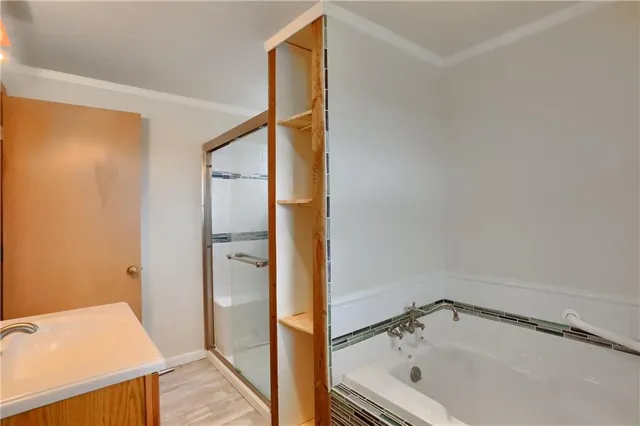 a bathroom with a tub and shower