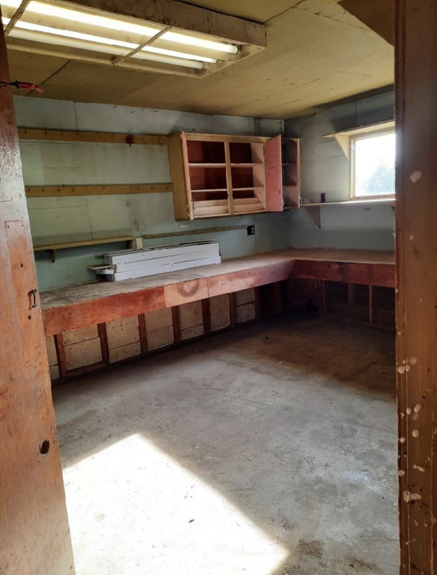 371 Lake Farm Road Port Angeles, WA 98362 - Photo 32 of 36 a room with wooden cabinets and a sink